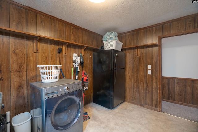 laundry area with light colored carpet, wood walls, a textured ceiling, and washer / dryer