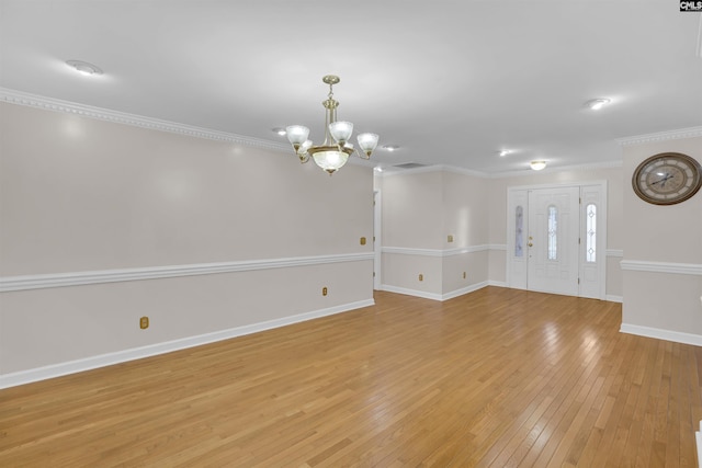 interior space featuring ornamental molding, light hardwood / wood-style floors, and a chandelier