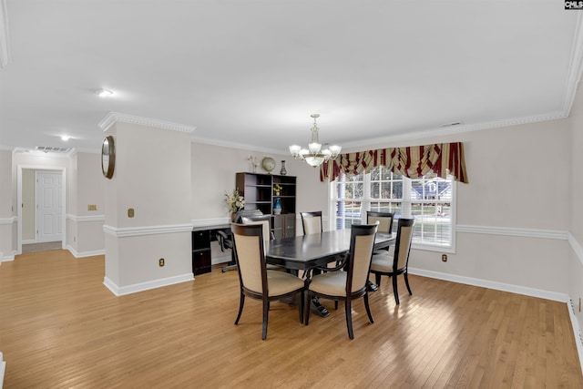 dining room featuring light wood-type flooring, a chandelier, and crown molding