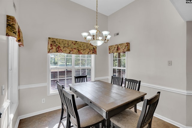 dining space featuring high vaulted ceiling, an inviting chandelier, and a healthy amount of sunlight