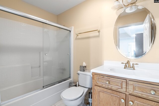 full bathroom featuring shower / bath combination with glass door, tile patterned floors, toilet, and vanity