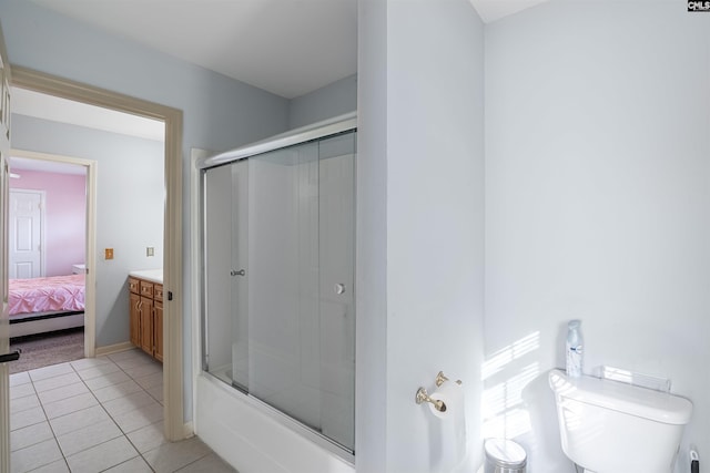 full bathroom featuring toilet, combined bath / shower with glass door, vanity, and tile patterned floors