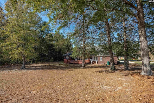 view of yard featuring a wooden deck