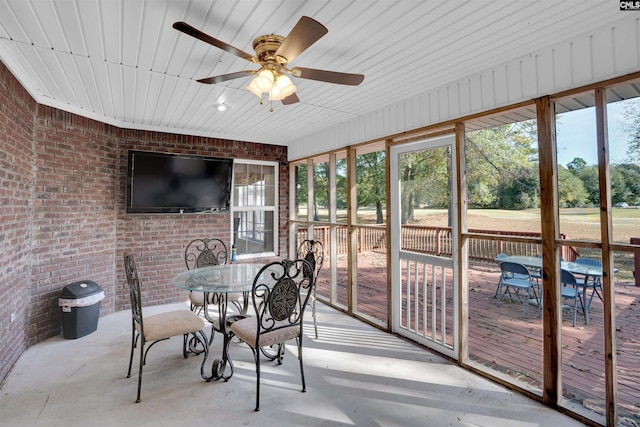 sunroom with wooden ceiling, ceiling fan, and plenty of natural light