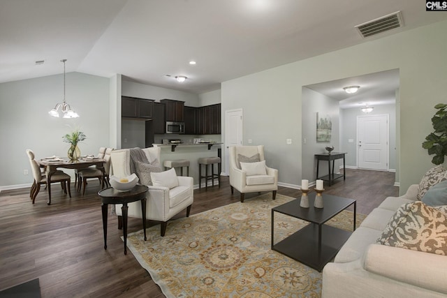 living room with dark hardwood / wood-style flooring, lofted ceiling, and a chandelier