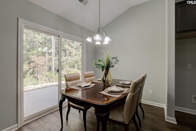 dining room featuring dark hardwood / wood-style floors, an inviting chandelier, and lofted ceiling