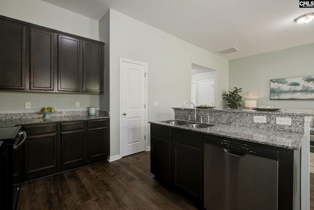 kitchen featuring stainless steel appliances, sink, light stone counters, a kitchen island with sink, and dark wood-type flooring