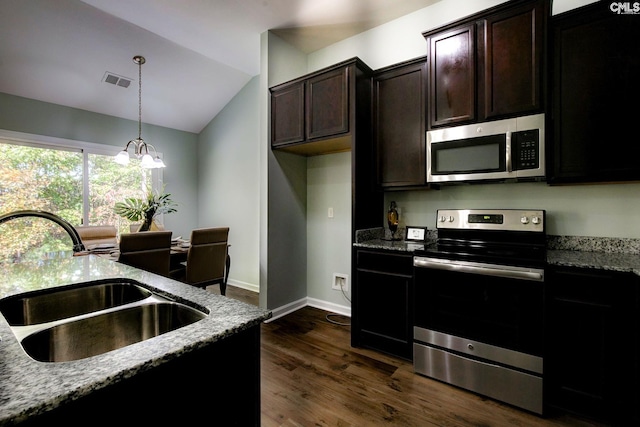 kitchen with light stone counters, appliances with stainless steel finishes, sink, dark wood-type flooring, and lofted ceiling