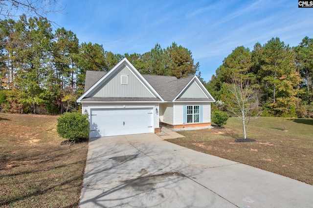 view of front of property with a front lawn and a garage