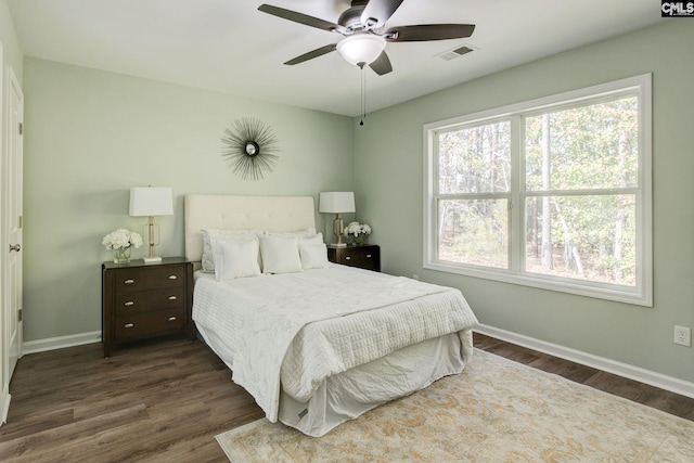 bedroom with dark wood-type flooring and ceiling fan