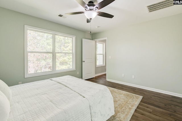 bedroom with dark wood-type flooring and ceiling fan