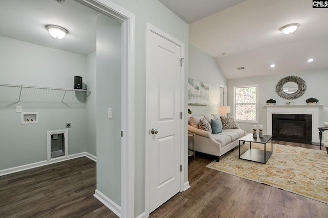 living room with dark wood-type flooring and vaulted ceiling