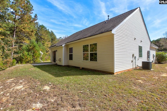 view of property exterior featuring central AC and a yard