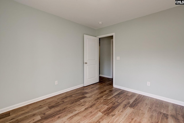 spare room with hardwood / wood-style flooring