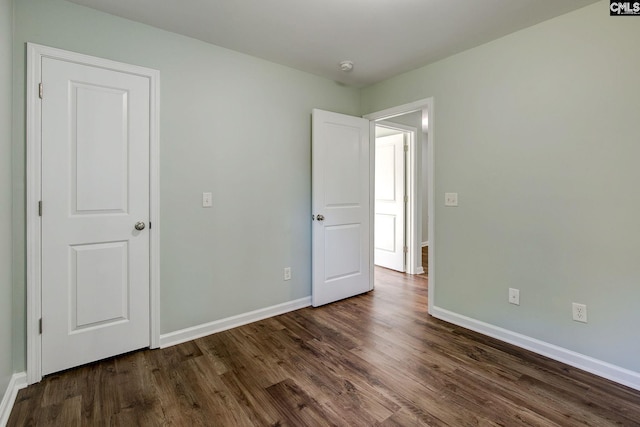 unfurnished bedroom featuring dark wood-type flooring