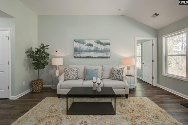 living room featuring dark hardwood / wood-style flooring and lofted ceiling