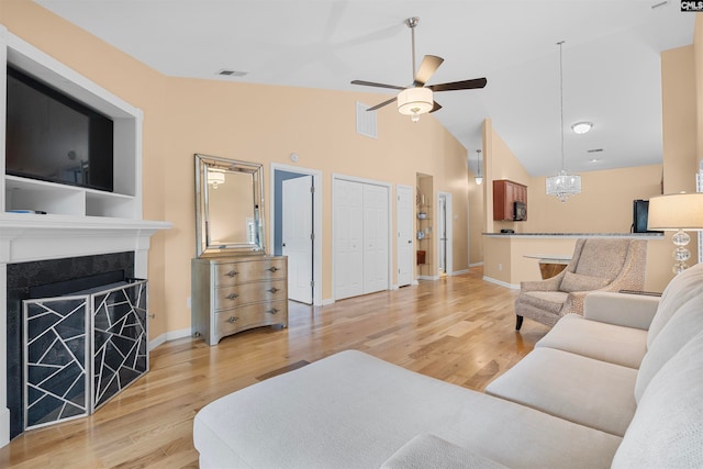 living room featuring hardwood / wood-style floors, ceiling fan, and high vaulted ceiling