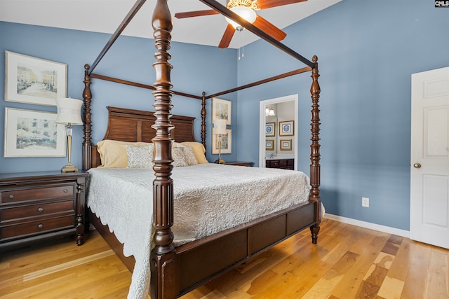 bedroom with ceiling fan, lofted ceiling, and light hardwood / wood-style floors