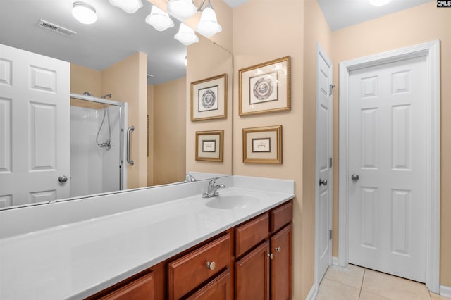 bathroom with tile patterned flooring, vanity, and a shower with shower door