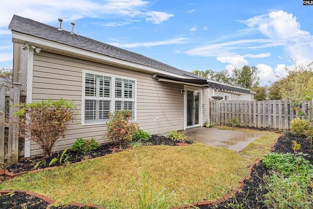 back of house featuring a yard and a patio area