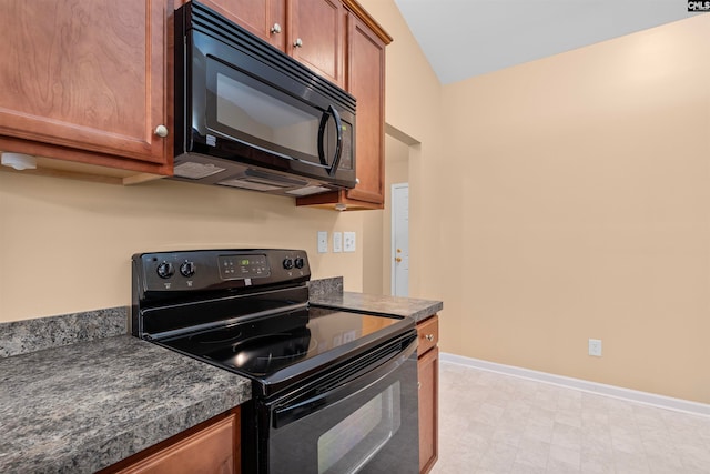 kitchen featuring black appliances and lofted ceiling