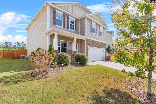 craftsman house with central AC unit, a garage, and a front lawn