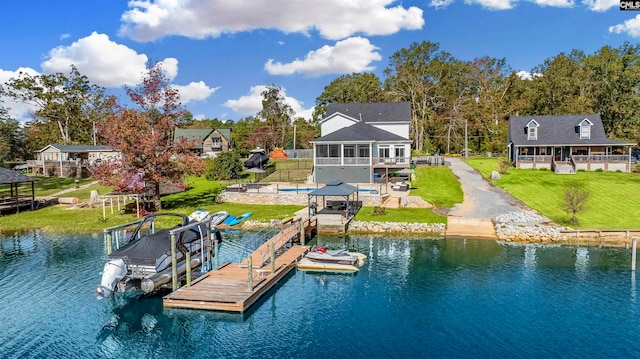 dock area with a yard and a water view