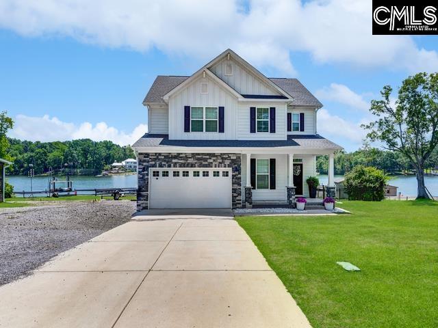 339 Newberg Rd, Chapin, SC 29036 - craftsman inspired home with board and batten siding, a porch, driveway, an attached garage, and a front yard