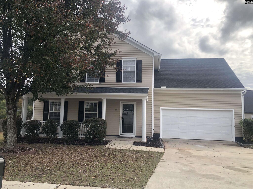 front of property featuring a garage and a porch