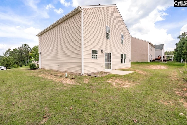 back of house featuring a yard and a patio