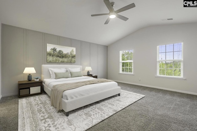 carpeted bedroom with ceiling fan and vaulted ceiling