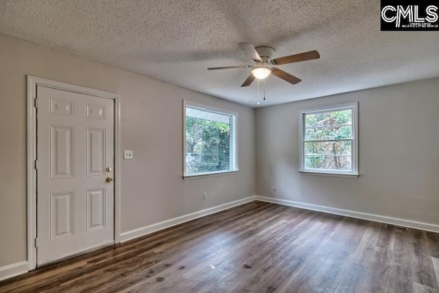 2230 Corning Rd, Columbia, SC 29205 - spare room featuring healthy amount of natural light, dark wood-style floors, ceiling fan, a textured ceiling, and baseboards
