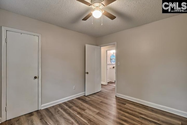2230 Corning Rd, Columbia, SC 29205 - unfurnished bedroom featuring wood finished floors, a textured ceiling, baseboards, and a ceiling fan