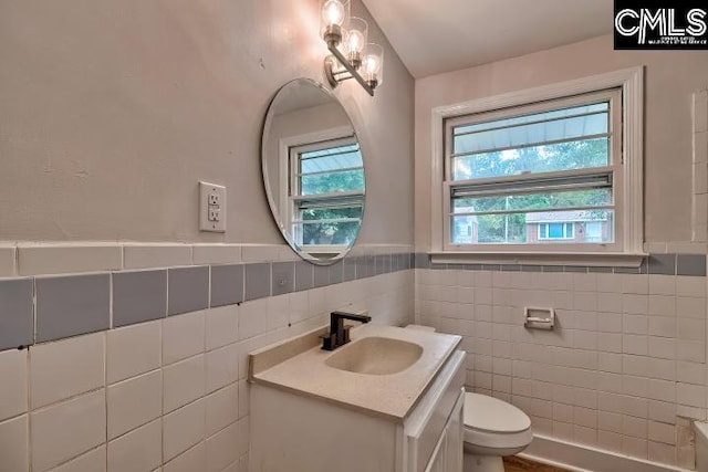 2230 Corning Rd, Columbia, SC 29205 - bathroom featuring tile walls, vanity, toilet, and a wainscoted wall