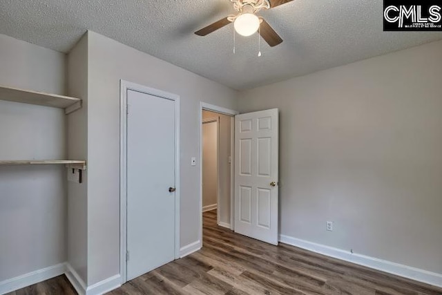 2230 Corning Rd, Columbia, SC 29205 - unfurnished bedroom with wood finished floors, a textured ceiling, baseboards, and a ceiling fan