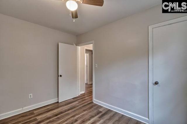 2230 Corning Rd, Columbia, SC 29205 - unfurnished bedroom with wood finished floors, baseboards, and a ceiling fan
