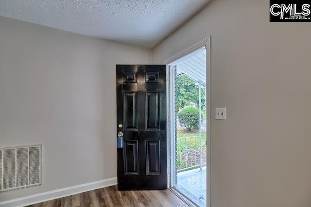 2230 Corning Rd, Columbia, SC 29205 - foyer with wood finished floors, baseboards, and a textured ceiling