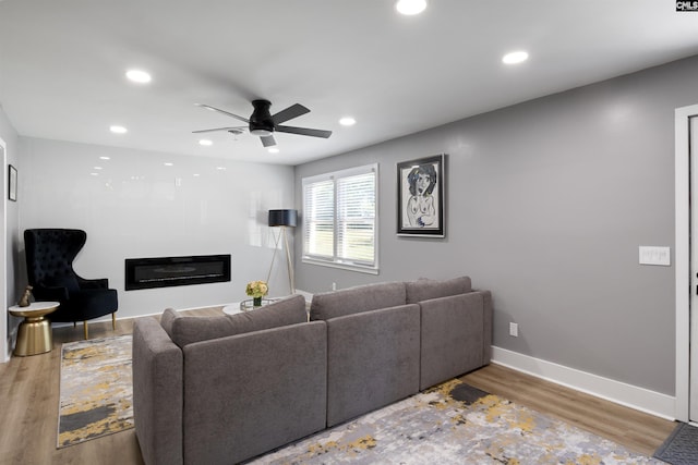 living room featuring ceiling fan and wood-type flooring