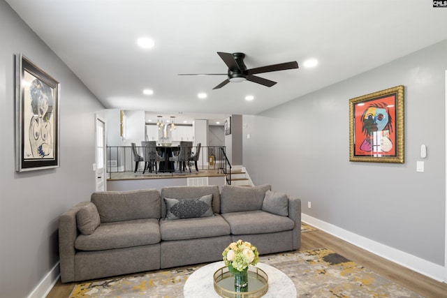 living room with hardwood / wood-style flooring and ceiling fan