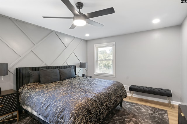 bedroom with hardwood / wood-style floors and ceiling fan