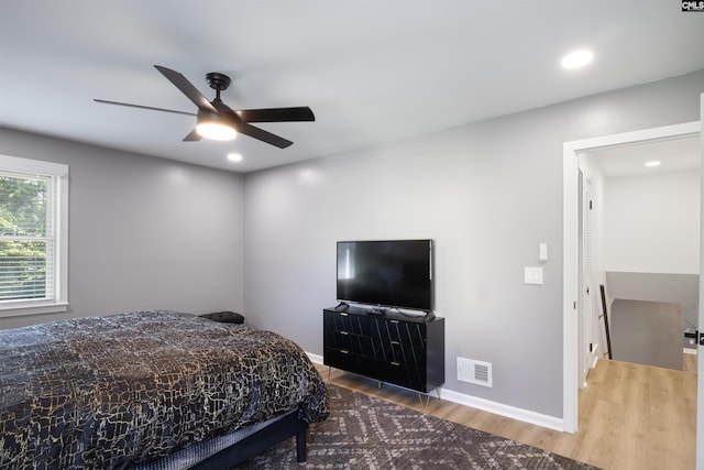 bedroom with hardwood / wood-style floors and ceiling fan