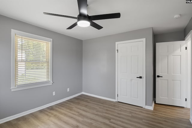 unfurnished bedroom featuring ceiling fan and light hardwood / wood-style floors