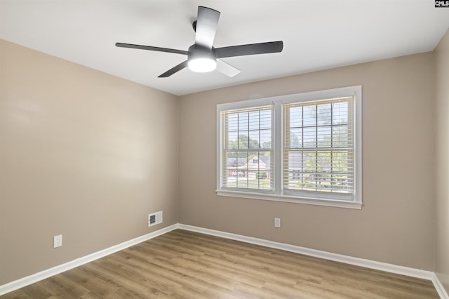 spare room featuring light hardwood / wood-style floors and ceiling fan