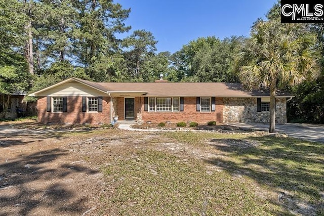 single story home with brick siding and a front yard