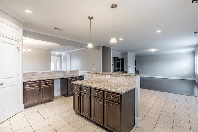 kitchen featuring decorative backsplash, dark brown cabinetry, and ornamental molding