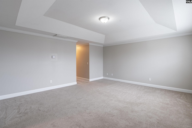 carpeted empty room featuring crown molding and a tray ceiling