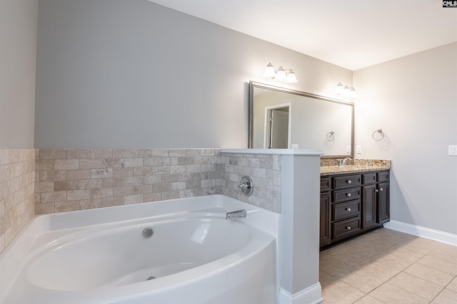 bathroom with a bathtub, vanity, and tile patterned flooring