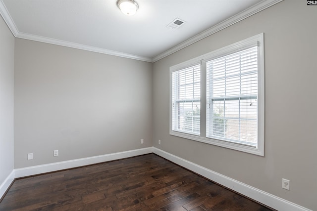 spare room with ornamental molding and dark hardwood / wood-style floors