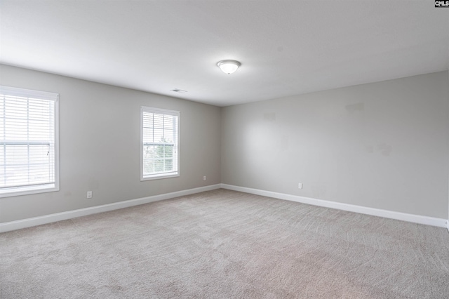 spare room with light carpet