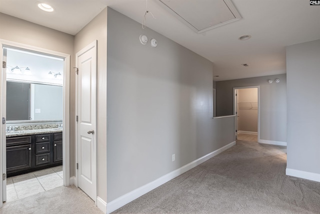 hallway featuring light colored carpet